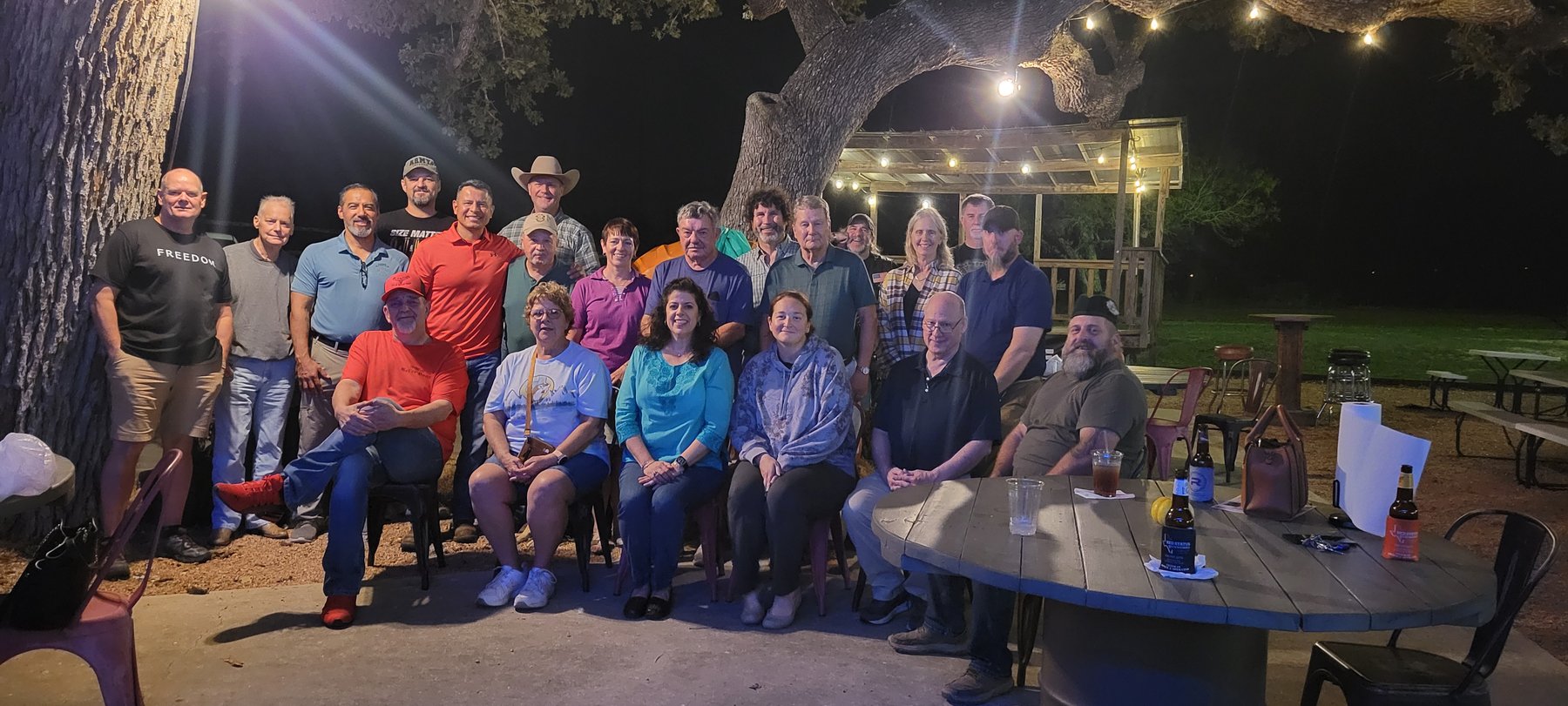 Veterans and seniors gathered outdoors at night